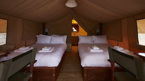 A tented room with two beds, each with pillows and a folded towel. - Enjoy the Silence Apartments by YourHost (Naivasha)