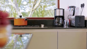 A kitchen with a stove, a coffee maker, and a toaster. - Enjoy the Silence Apartments by YourHost (Naivasha)