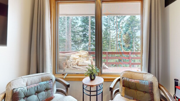 A room with two chairs facing a large window overlooking a deck with a wooden railing. - Pet-Friendly Spacious & Bright Home, Mountain Modern. Walk To The Village (Mammoth Lakes)