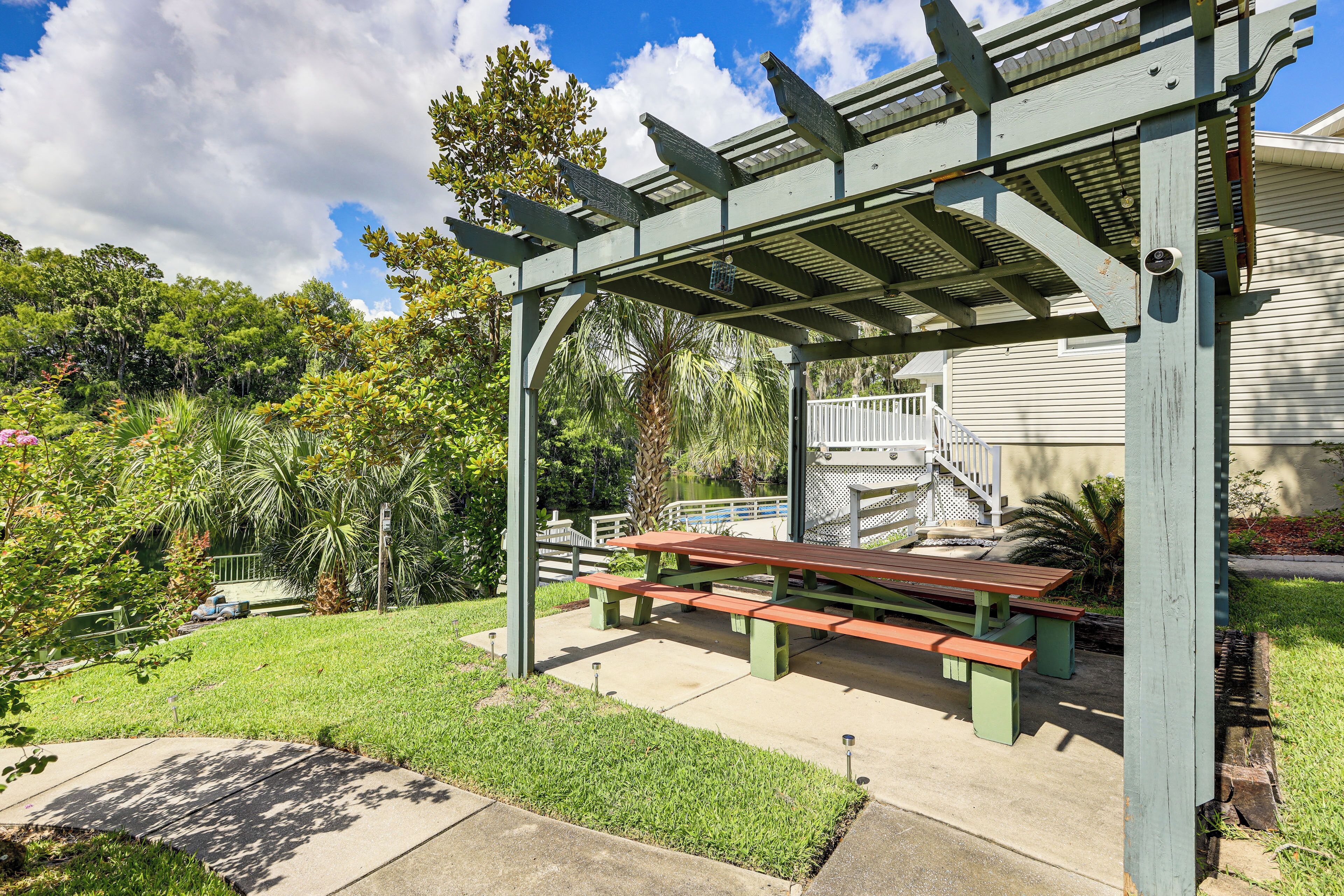 A covered picnic area with benches and a pergola structure.