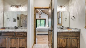 A bathroom with two sinks, wooden cabinets, and a ceiling fan. - Branson Gem w/ Hot Tub Access & Private Boat Slip! (Branson)