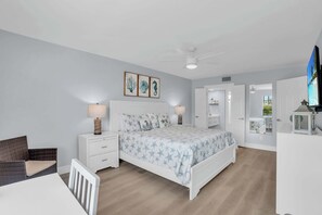 A bedroom with a bed, nightstands, a chair, a desk, and a TV. - F-237 - Deluxe Condo - Amazing Views and Sleeps 6 (Naples)