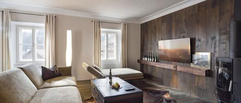 Una sala de estar moderna con un sofá de cuero, una mesa de centro de madera y una chimenea.
