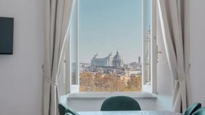 A room with a large window, curtains, a bed, and a chair. - Authentic Architectural Gem in the Heart of Rome
 (Roma)