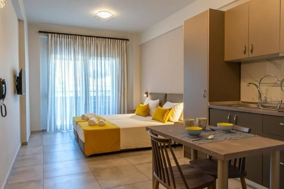 Ein Hotelzimmer mit Bett, Esstisch und Küchenzeile.