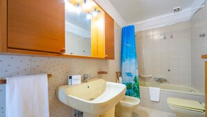 Ein Badezimmer mit Waschbecken, Bidet, Toilette und Badewanne.