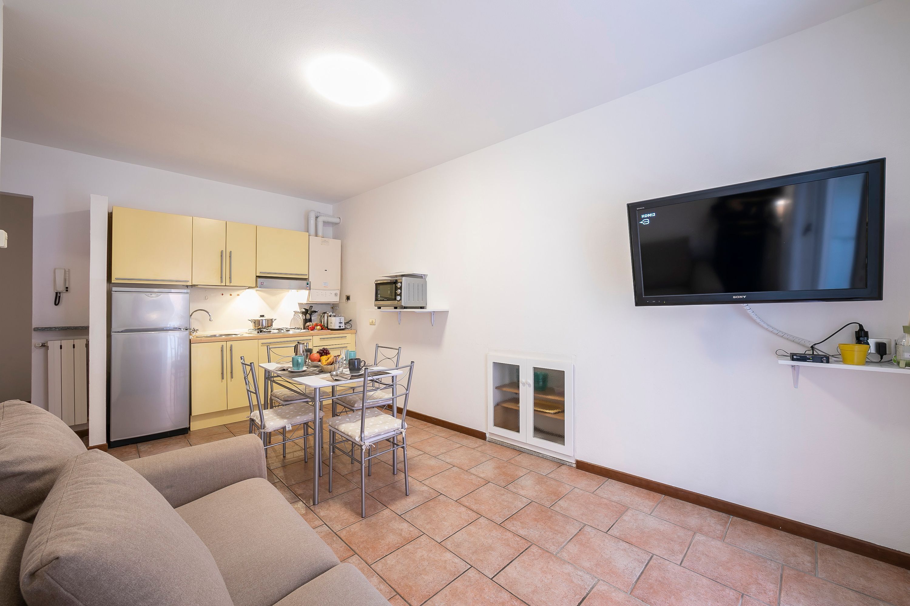 A compact living space with a kitchenette, a dining area, and a seating area.