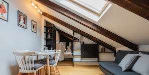 A modern loft apartment with a dining area, a sofa, and a skylight. - Barbaroux Apartment - Sole by Wonderful Italy (Turin)