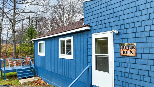 A small blue building with a sign that reads "DEER RUN." - ATV ACCESS/WALK TO TOWN (Greenville)