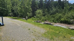 A gravel path leading to a building with a porch, surrounded by a forested area. - ATV ACCESS/WALK TO TOWN (Greenville)