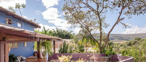 A patio area with outdoor furniture, a cactus garden, and a view of the countryside.