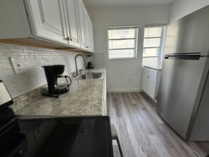 Standard Apartment | Private kitchen | Full-size fridge, oven, electric kettle, toaster - Remodeled apartments in little havana (Miami)