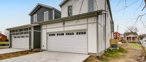 A two-story house with a garage and a covered driveway.