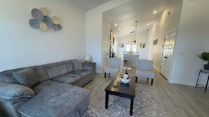 A modern living room with a grey sectional sofa, a coffee table, and a rug. - Family-Friendly Retreat in Canyon Lake (Canyon Lake)