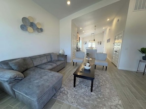 A modern living room with a grey sectional sofa, a coffee table, and a rug. - Family-Friendly Retreat in Canyon Lake (Canyon Lake)