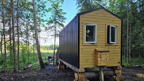 A small wooden cabin with two windows, a door, and a small porch area. - Wood Duck Cabin, No Neighbours, Drive too, Pet Friendly (Golden Lake)