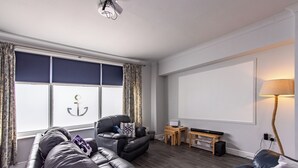 A modern living room with a leather sofa, a wooden coffee table, and a flat-screen TV. - Maritime House II (Hull)