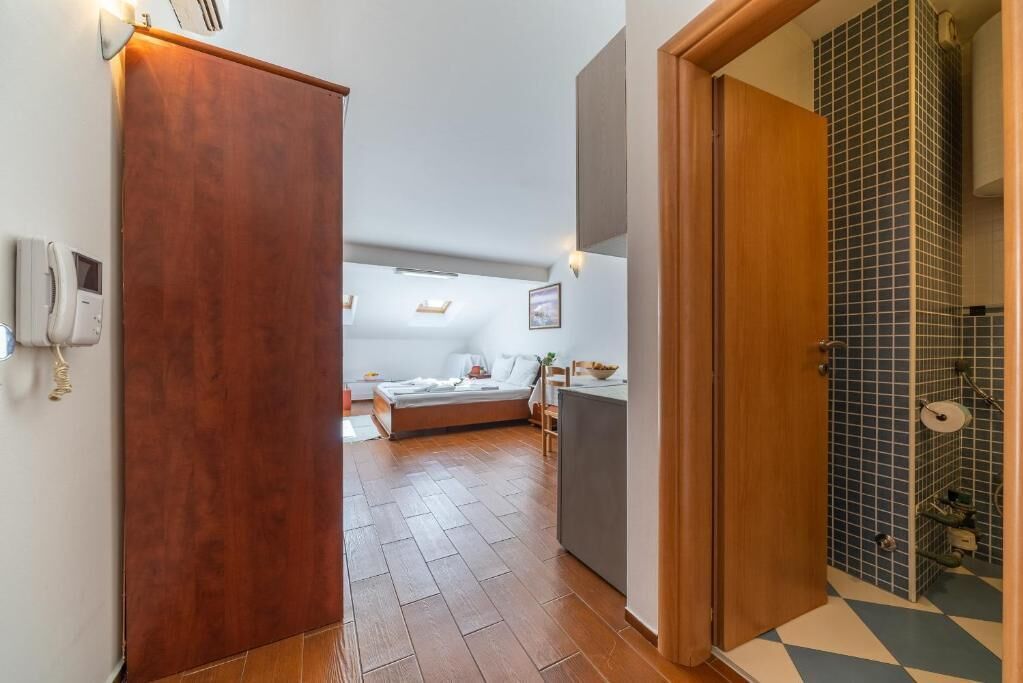 Family Studio, Balcony, City View | Living area | 32-inch LCD TV with cable channels