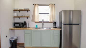 Fridge, microwave, coffee/tea maker, cookware/dishes/utensils