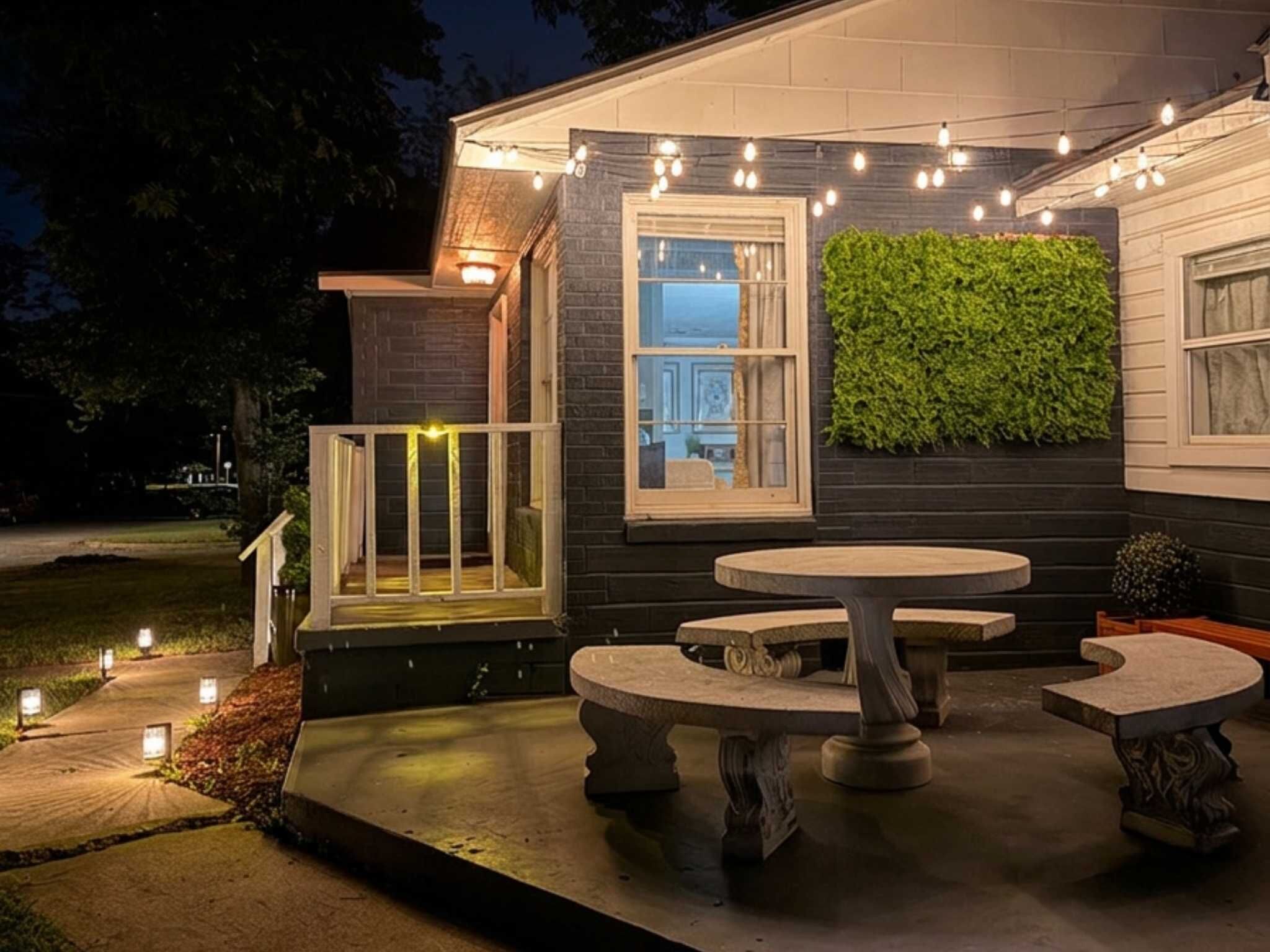 A house with a porch, a table, and a bench.