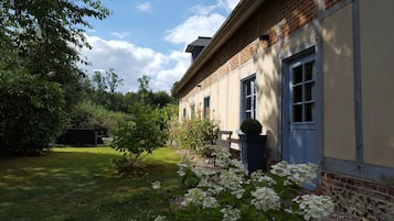 Enjoy a serene atmosphere amidst lush gardens and a charming brick building.