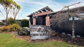 A wooden sign with the text "SNOW-VANNAH" and a mountain logo, indicating a mountain resort or lodge.