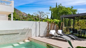 A swimming pool with steps leading into it, surrounded by a white wall and a pergola with chairs. - El Higueron Townhouse With Private Pool by Costarentals - Ref 252 (Benalmádena)
