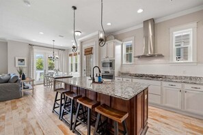 Enjoy cooking in this well-equipped kitchen with a large island and modern appliances.