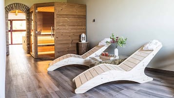 Relax in a serene spa room with a sauna, wooden loungers, and a tranquil atmosphere.