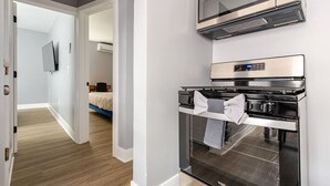 A kitchen with a microwave, oven, and a digital control panel. - Modern 2 Bedroom in Black Rock (Bridgeport)