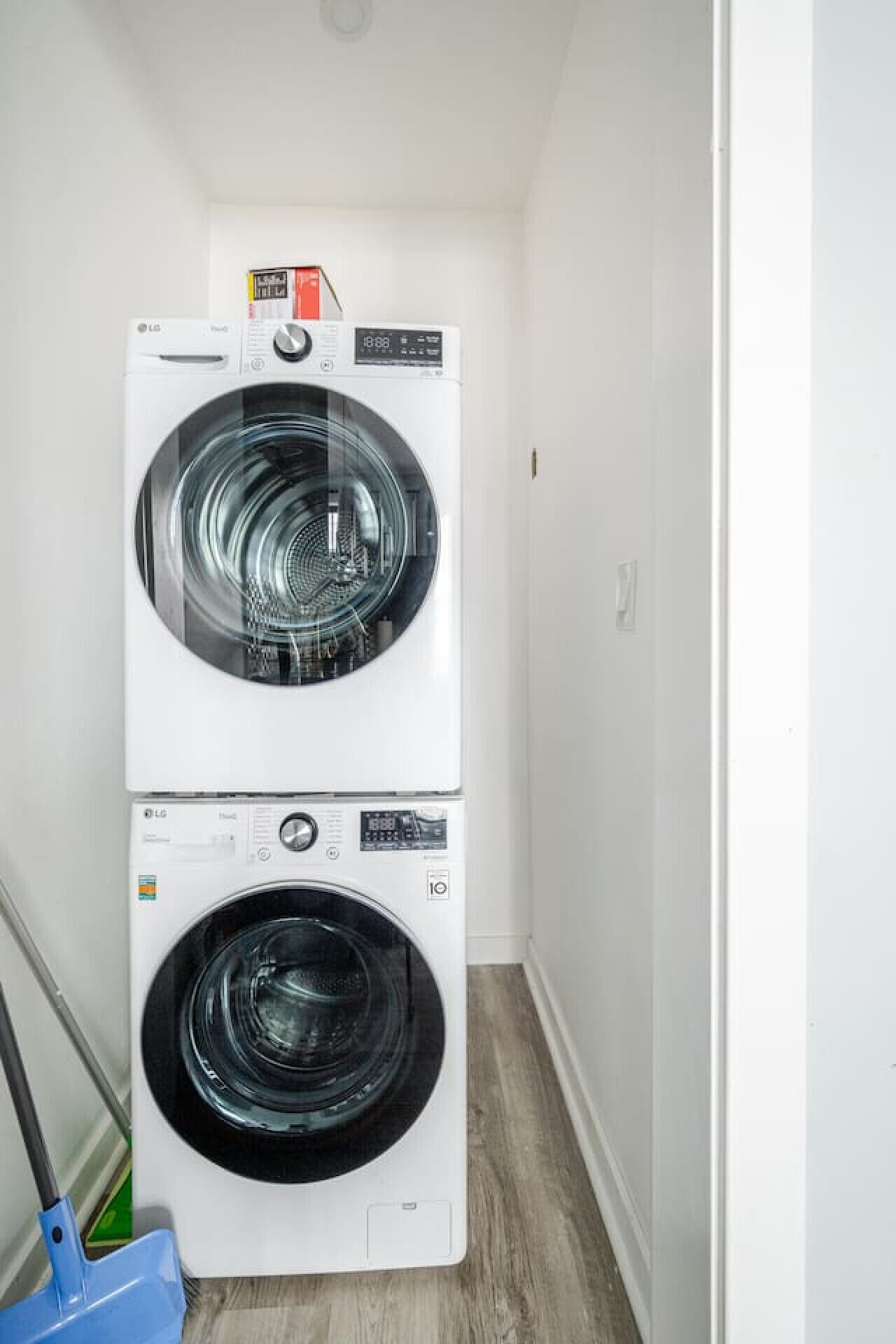 A laundry room with two stacked front-loading washing machines.