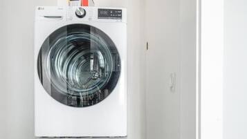 A laundry room with two stacked front-loading washing machines.
