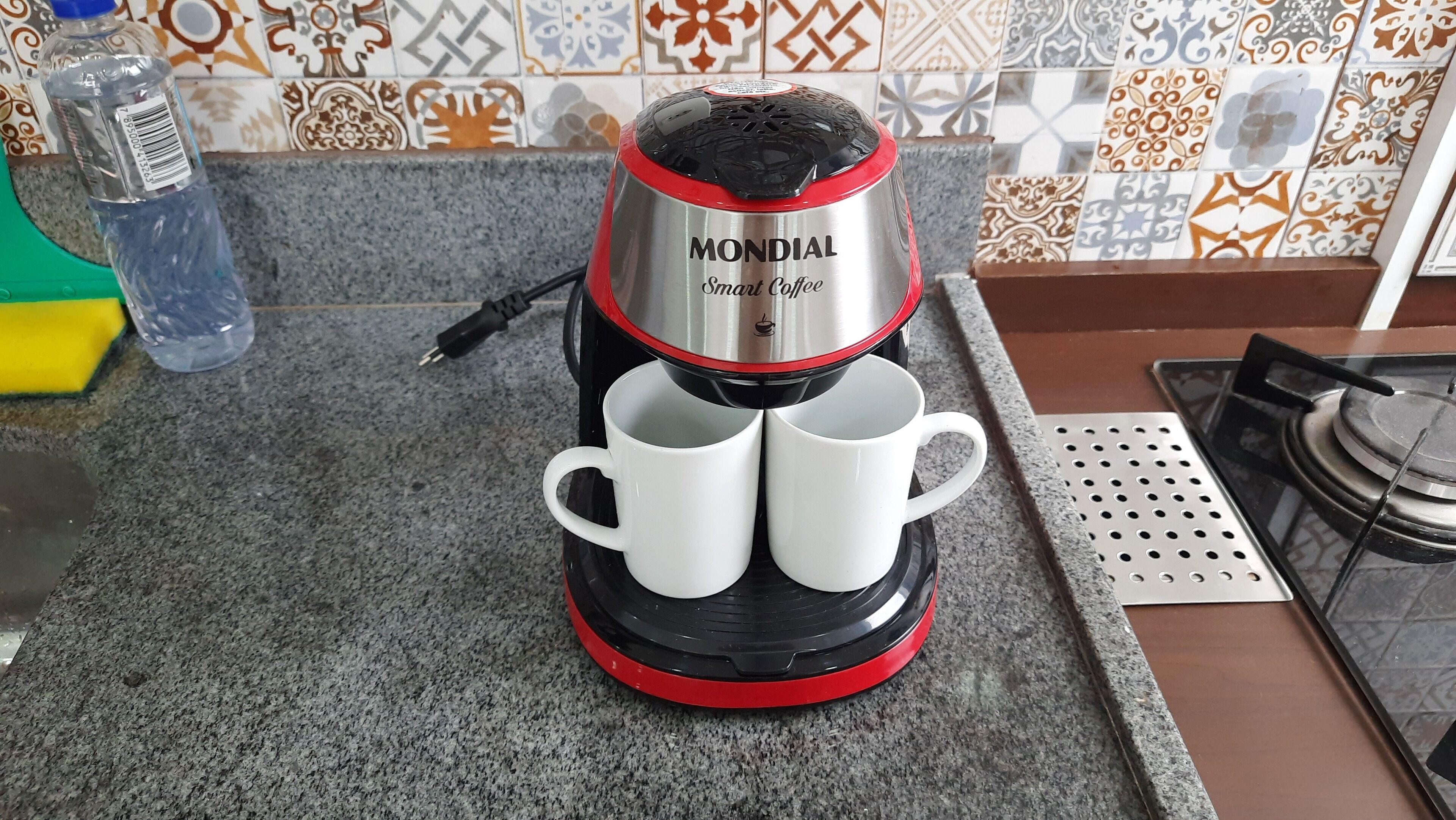 A Mondial Smart Coffee maker with two white mugs on a kitchen counter.