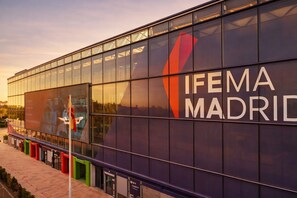 A modern building with a large glass facade and the text "IFEMA MADRID" prominently displayed.