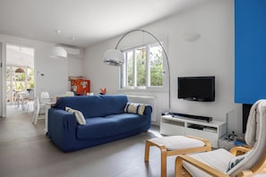 Villa, Garden View | Living area | 35-inch TV with digital channels