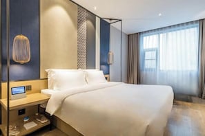 A modern hotel room with a large bed, a bedside table with a control panel, and a large window with curtains. - Orange Hotel (Zhengzhou Hongzhuan Road) (Zhengzhou)
