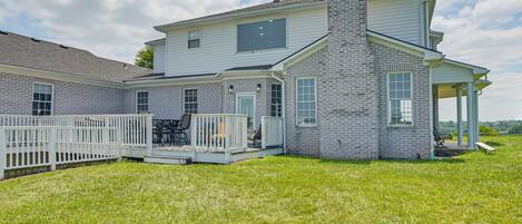 A two-story house with a porch and a fenced deck.