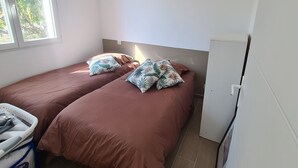 A bedroom with two beds, a window, and a white wardrobe. - Rent mini villa between sea and mountains... (VENTISERI)