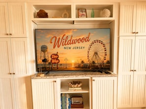 Un téléviseur diffusant une scène de Wildwood, dans le New Jersey, avec un château d’eau et une grande roue.