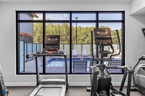 Work out with a view of the pool and surrounding landscape from this fitness room, featuring treadmills and elliptical machines.