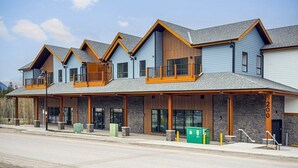A row of modern, multi-story buildings with a consistent architectural style, featuring large windows and wooden balconies. - The Westview - 2 Bed/2Bath Sleeps 6 (Dead Man's Flats)