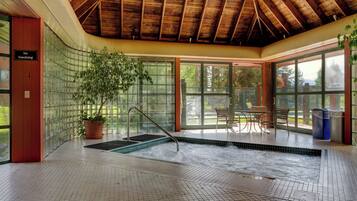 A spa area with a hot tub, a potted plant, and a 'No Smoking' sign.