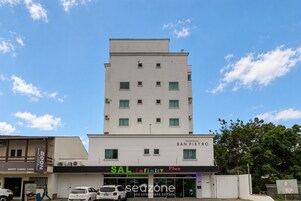 Un edificio de varios pisos con un letrero que indica 'SAL Infinity Plus' y 'RESIDENCIAL SAN PIETRO', señalando que se trata de una propiedad residencial y comercial.