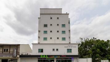 A multi-story building with a commercial ground floor featuring a restaurant named 'SAL Infinity Plus'.
