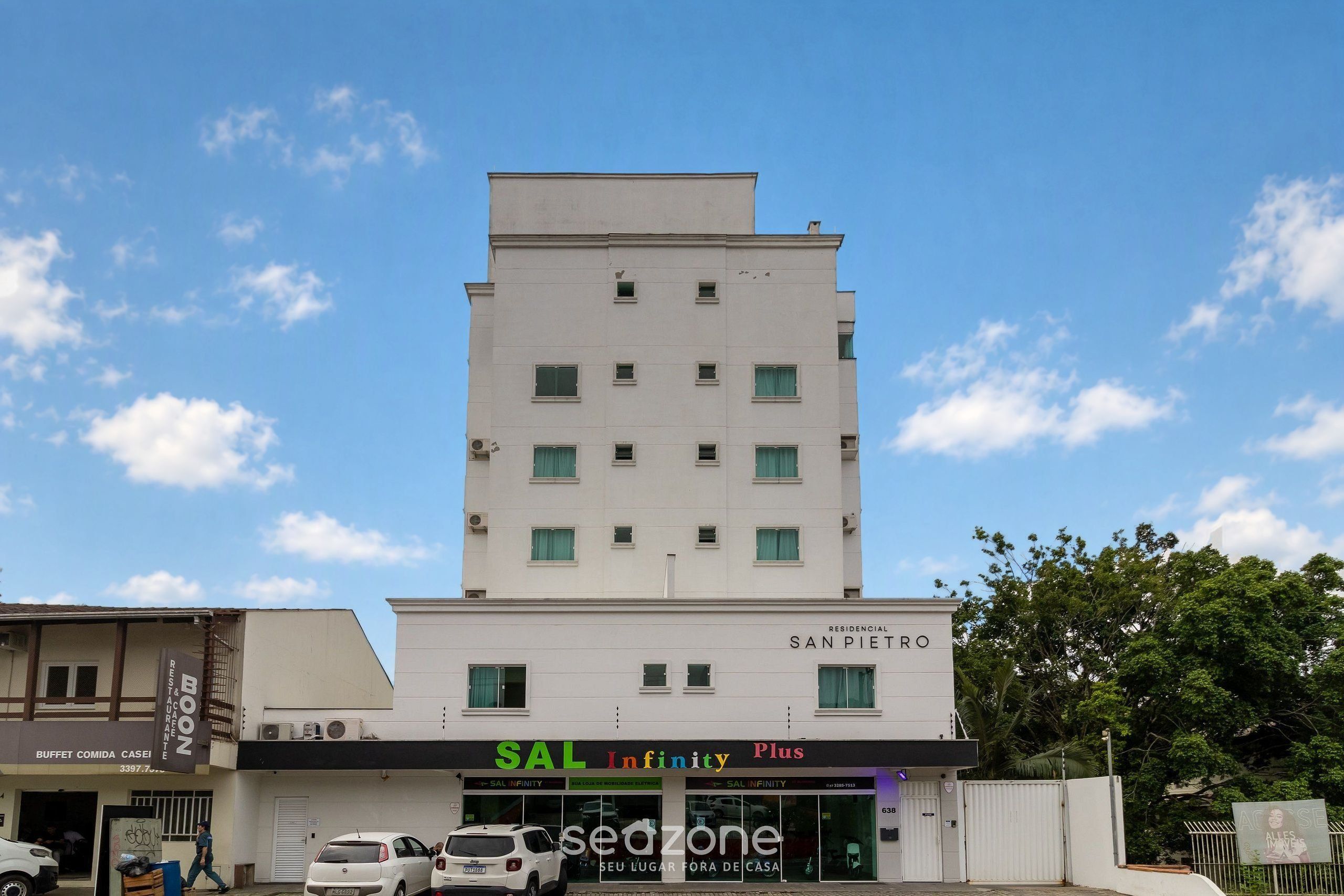 A multi-story building with a sign for 'RESIDENCIAL SAN PIETRO' and a storefront for 'SAL Infinity Plus'.