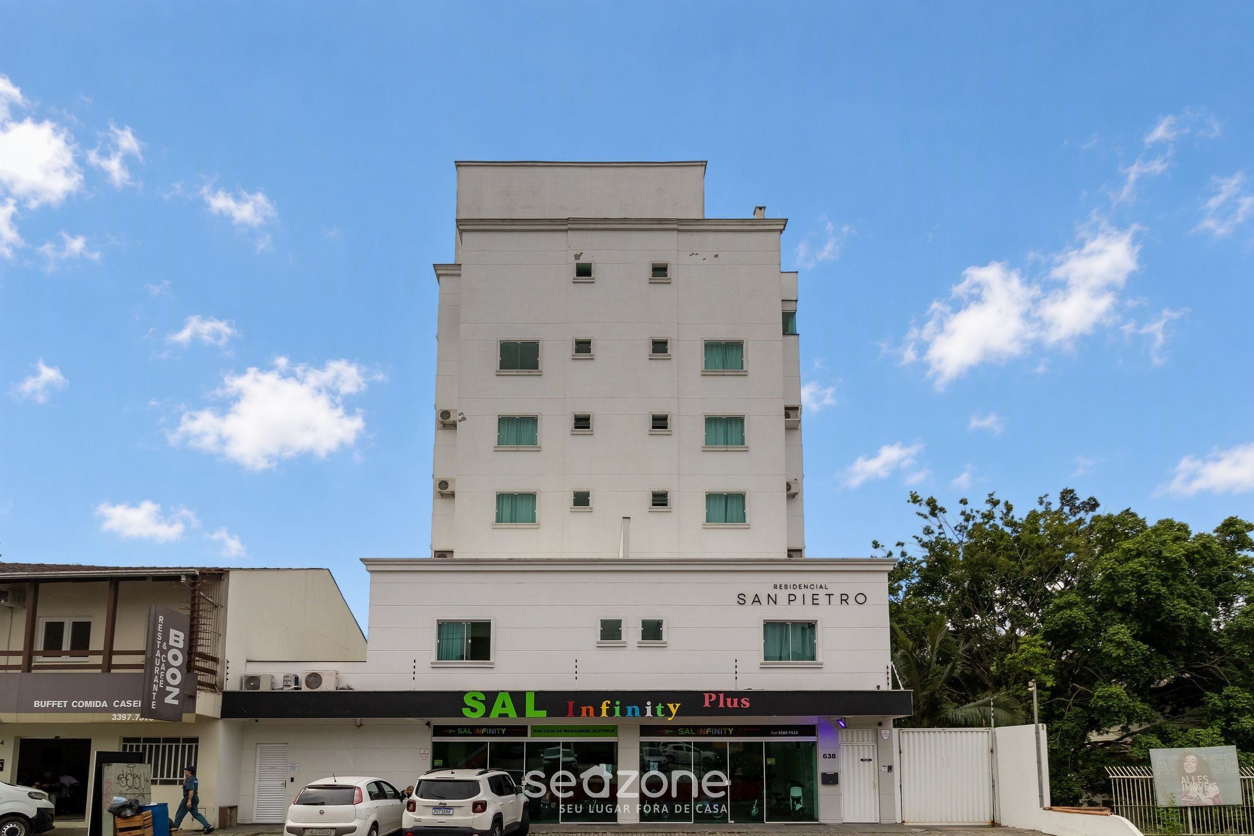 A multi-story building with a sign for 'SAL Infinity Plus' and 'RESIDENCIAL SAN PIETRO'.