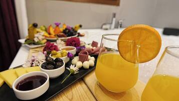 A tray with various food items and drinks, including a glass of orange juice with an orange slice garnish.