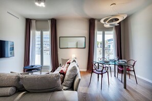 Apartment, Balcony, City View | Living area | 35-inch TV with digital channels