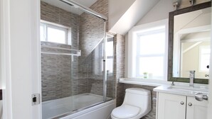 A bathroom with a glass-enclosed shower, a toilet, and a vanity with a mirror. - Centrally located 2 bedroom 1.5 bathroom, 15 mins to DT Vancouver (Vancouver)