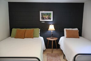 A room with two beds, a small table with a lamp, and a framed picture on the wall. - Newly Renovated Lake Suite 4, Full Kitchen, Private Beach + Dock Access (Holderness)